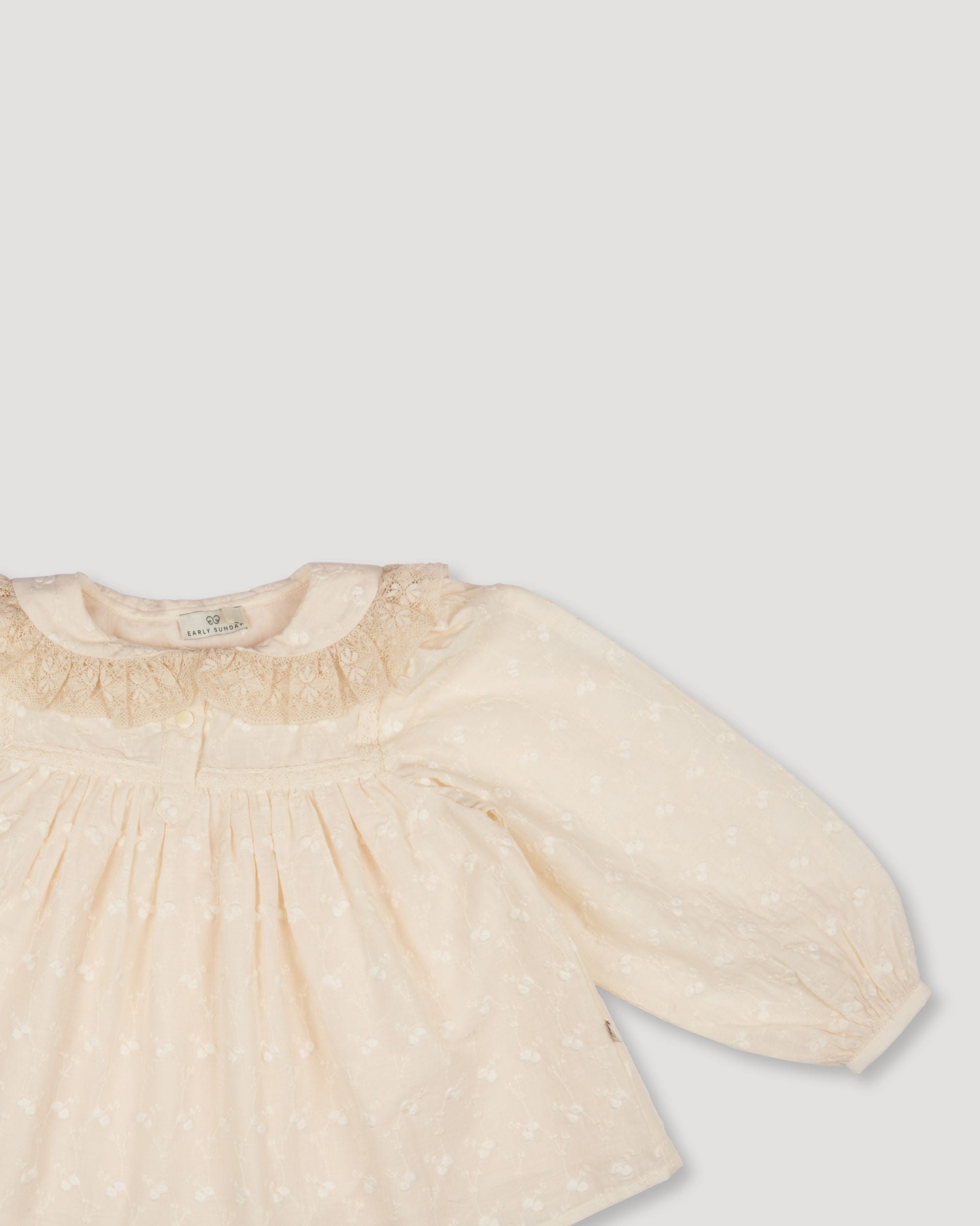 Early Sunday, Rosa Blouse in Hazelnut Cream, made from All-Over Embroidered Cotton Cambric fabric, featuring Frilled neckline detailed with a lace collar for a vintage touch, shown in a closeup flat-lay view