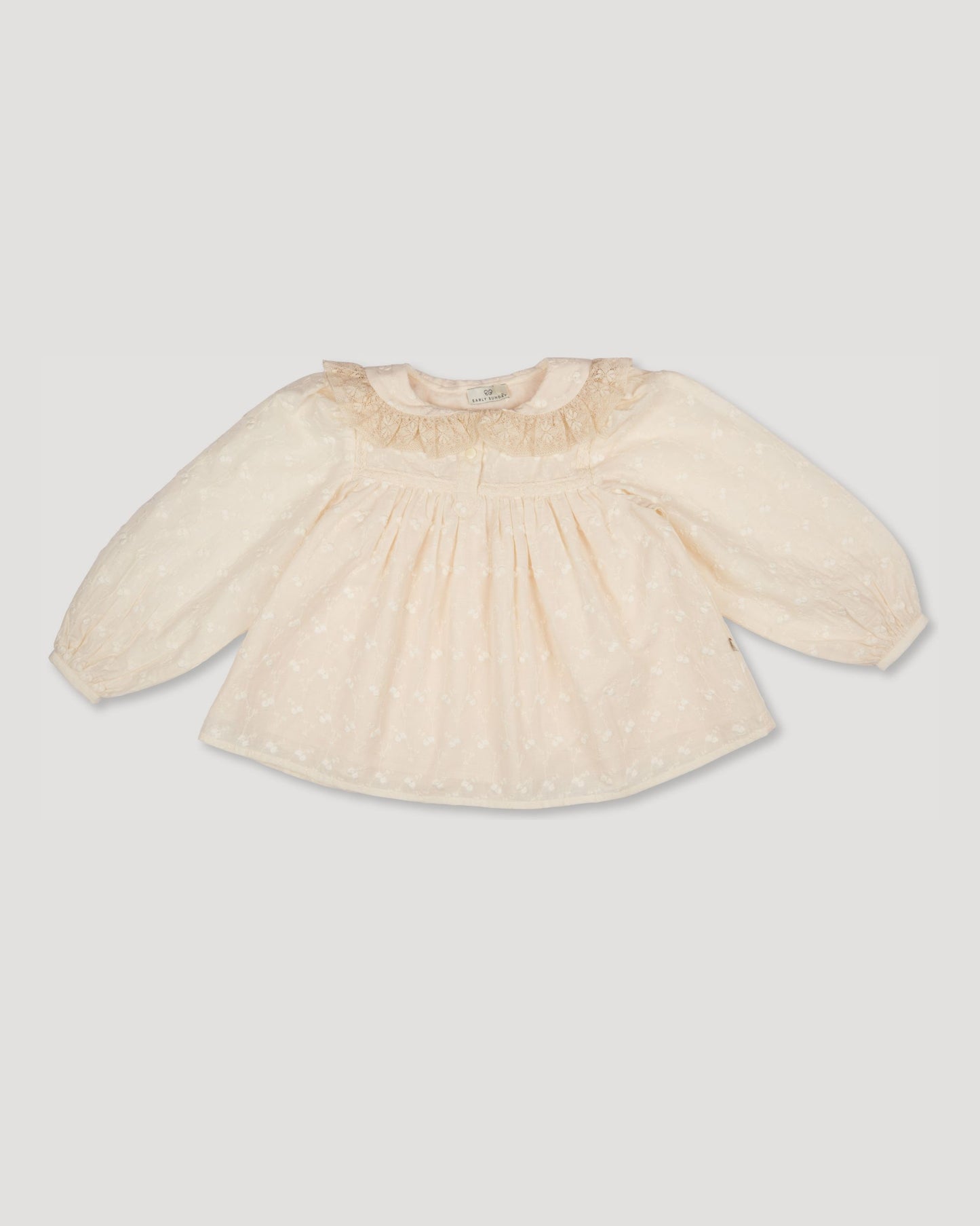 Early Sunday, Rosa Blouse in Hazelnut Cream, made from All-Over Embroidered Cotton Cambric fabric, featuring Frilled neckline detailed with a lace collar for a vintage touch, shown in a front flat-lay view