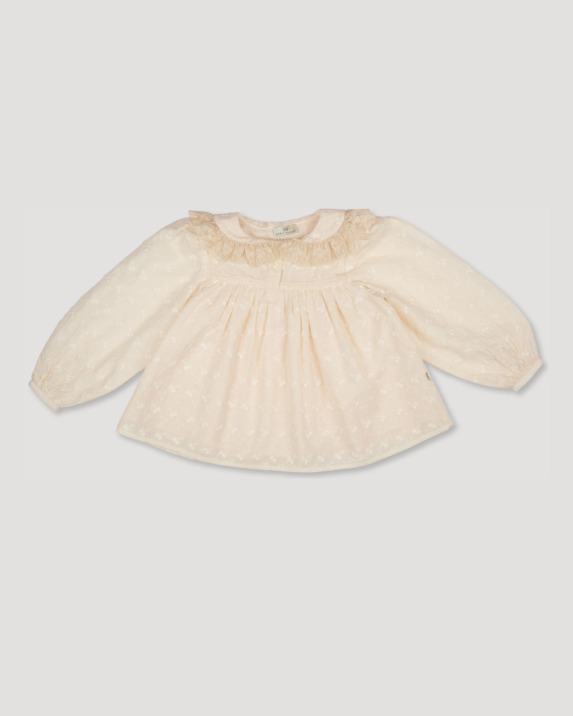 Early Sunday, Rosa Blouse in Hazelnut Cream, made from All-Over Embroidered Cotton Cambric fabric, featuring Frilled neckline detailed with a lace collar for a vintage touch, shown in a front flat-lay view