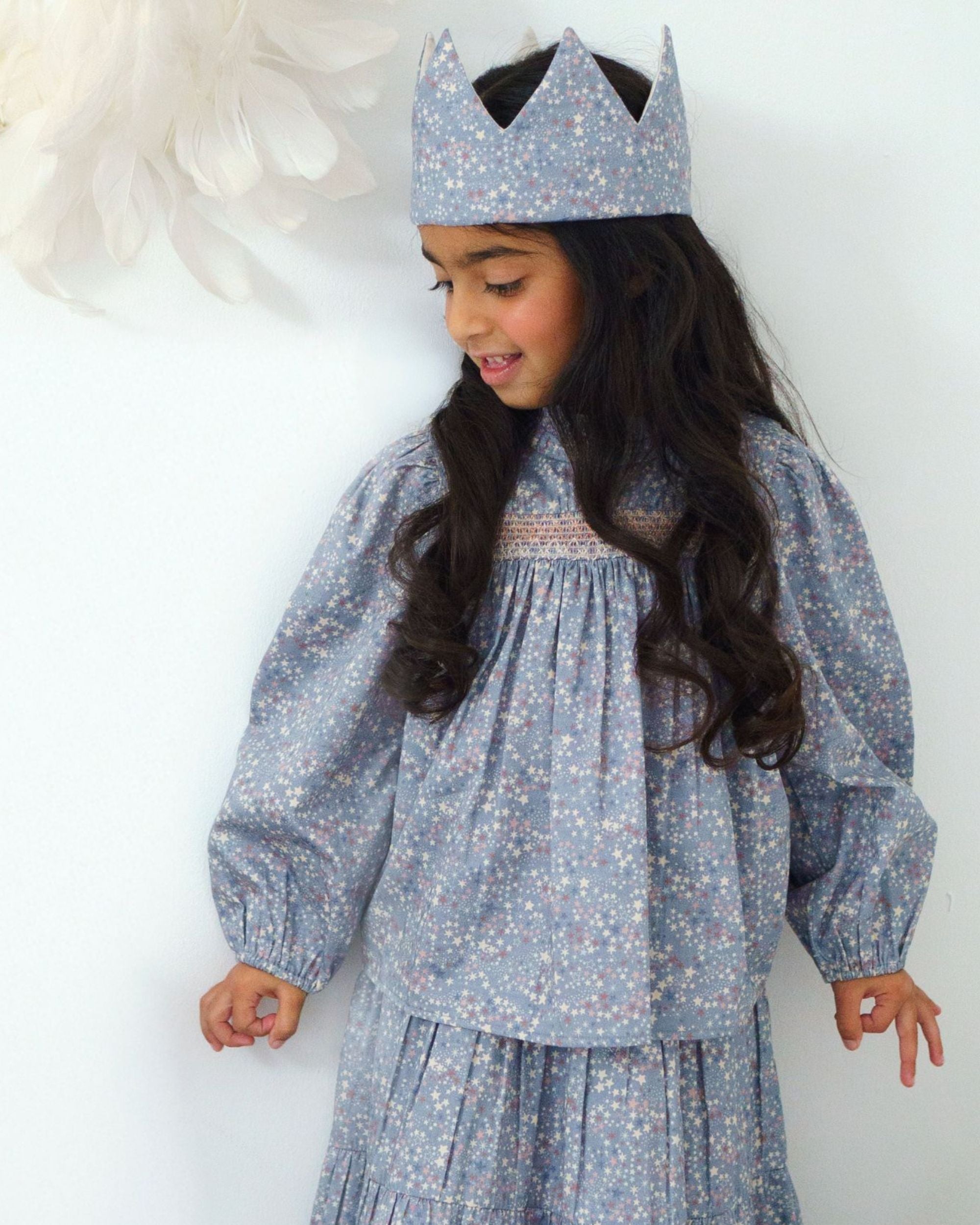 Early Sunday, Rosa Blouse in Celestial print, made from Printed Cotton Satin fabric, featuring Frilled neckline detailed with a lace collar for a vintage touch, shown in a front view of a model wearing it in a studio setting