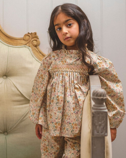 Early Sunday, Rosa Blouse in Floral print, made from Printed Cotton Satin fabric, featuring Frilled neckline detailed with a lace collar for a vintage touch, shown in a front view of a model wearing it in a studio setting