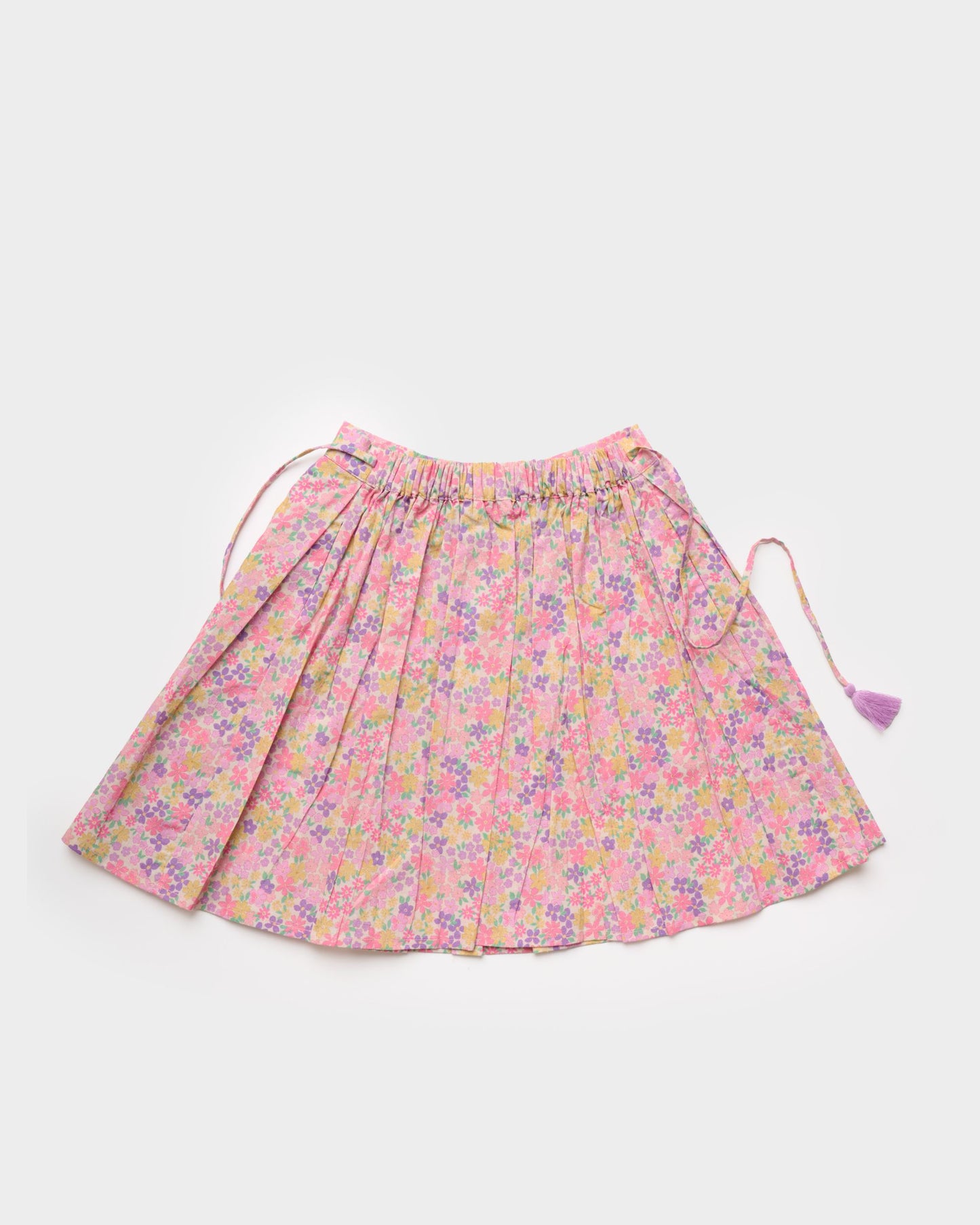 Early Sunday, Ruth Skirt in Emma Floral Purple color, made from Organic Printed Cotton Cambric fabric, featuring a flared silhouette with an elastic waistband & floral design, shown in a back flat-lay view