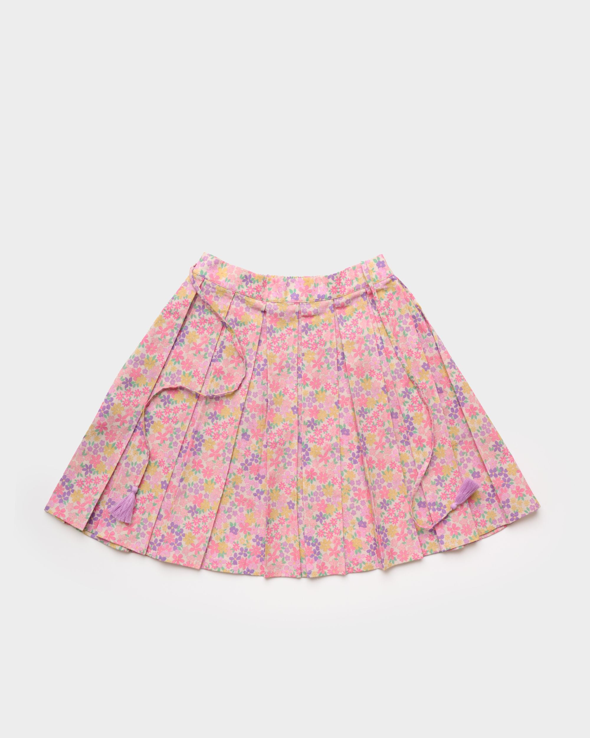 Early Sunday, Ruth Skirt in Emma Floral Purple color, made from Organic Printed Cotton Cambric fabric, featuring a flared silhouette with an elastic waistband & floral design, shown in a front flat-lay view