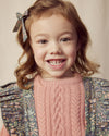 Early Sunday, Selma Skirt in Autumn Garden Greyish Blue, made from Printed Cotton Satin fabric, featuring dungaree style with adjustable straps, shown in a close-up shot of a model wearing it during a studio shoot