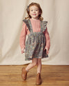 Early Sunday, Selma Skirt in Autumn Garden Greyish Blue, made from Printed Cotton Satin fabric, featuring dungaree style with adjustable straps, shown in a front view of model wearing it