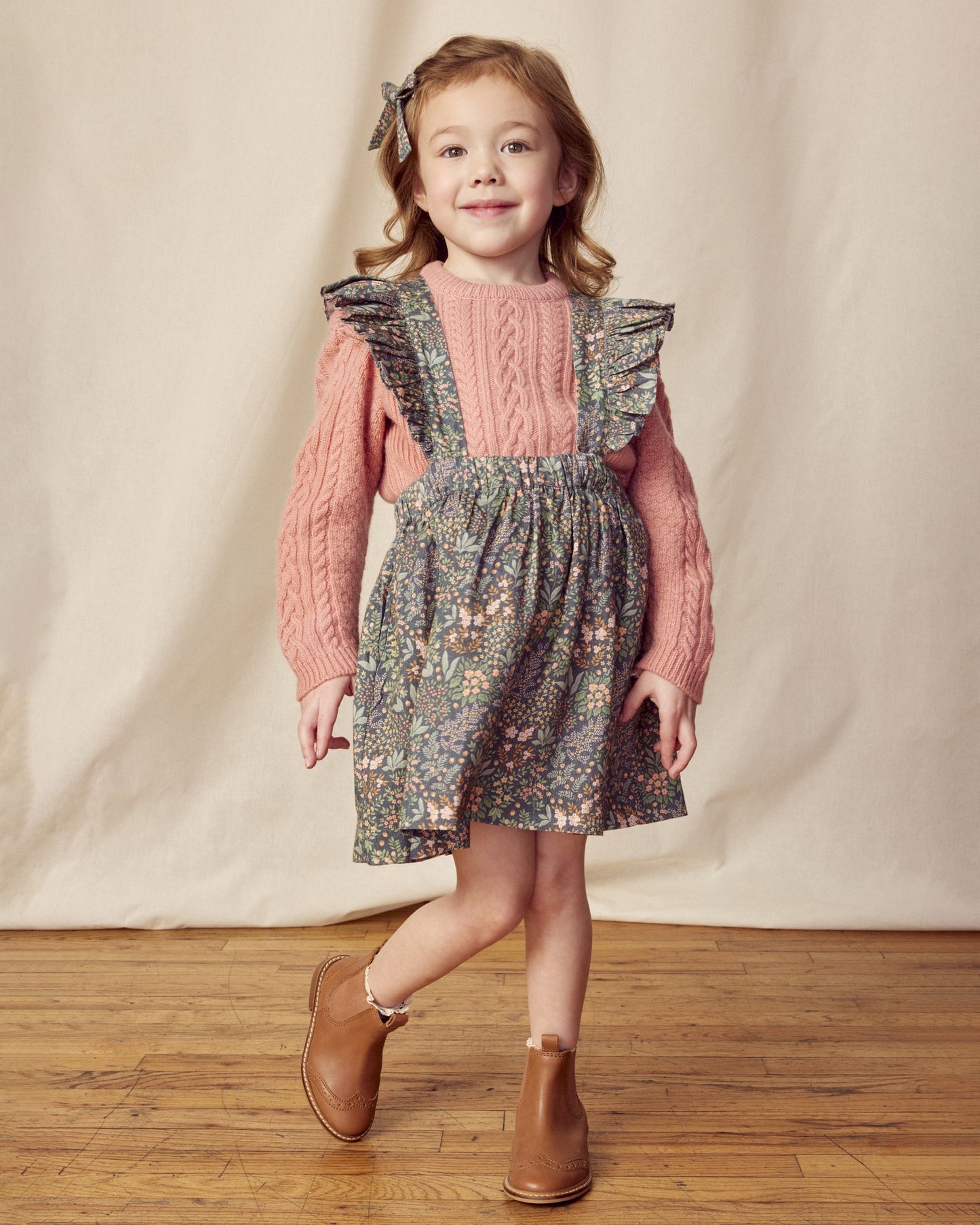 Early Sunday, Selma Skirt in Autumn Garden Greyish Blue, made from Printed Cotton Satin fabric, featuring dungaree style with adjustable straps, shown in a front view of model wearing it