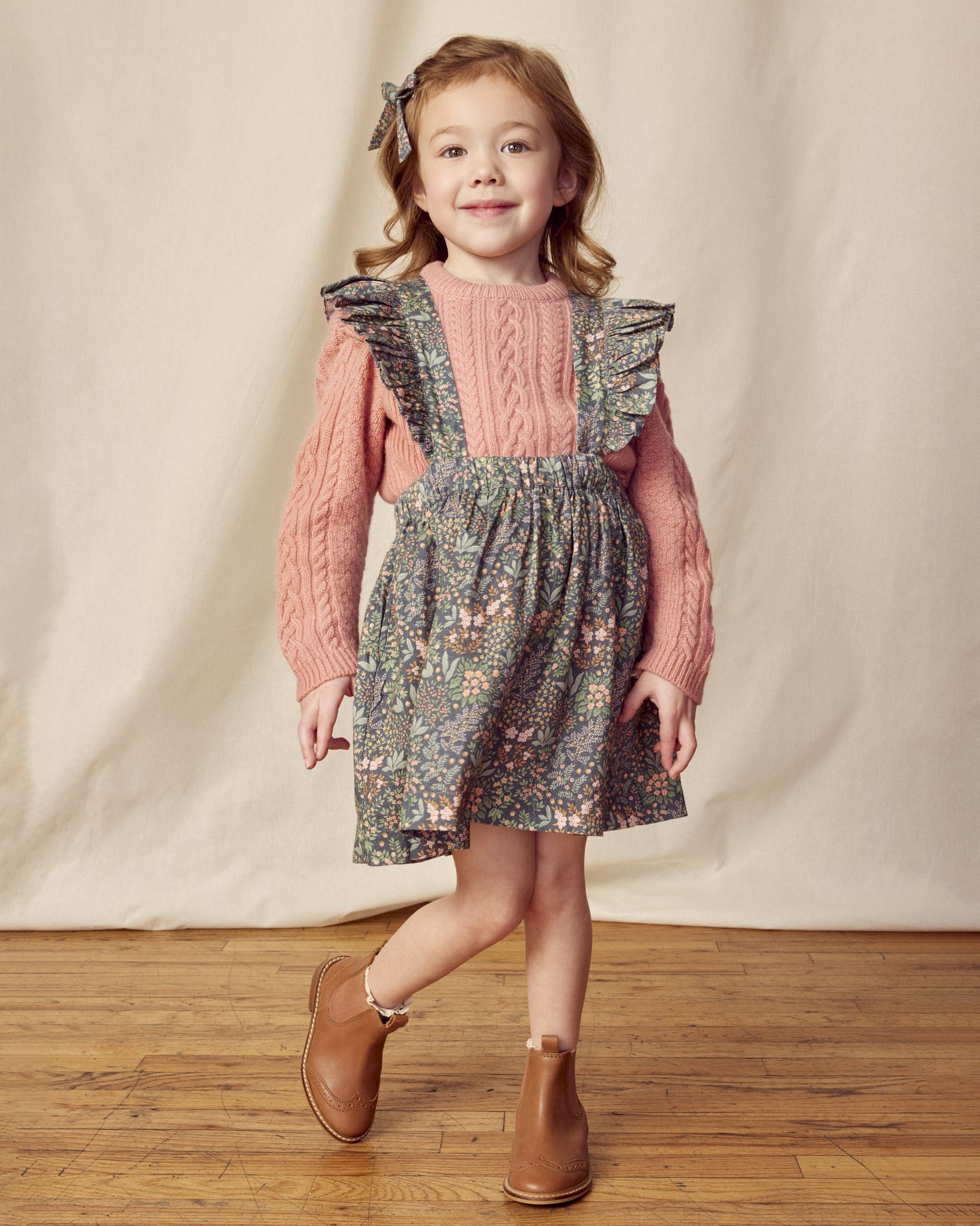 Early Sunday, Selma Skirt in Autumn Garden Greyish Blue, made from Printed Cotton Satin fabric, featuring dungaree style with adjustable straps, shown in a front view of model wearing it