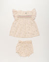 Early Sunday, Sienna Baby Dress & Bloomer Set in Painted Bouquet print, made from 70% Cotton 30% Linen fabric, featuring a relaxed fit with smocked chest band & frilled sleeves, shown in a front flat-lay view