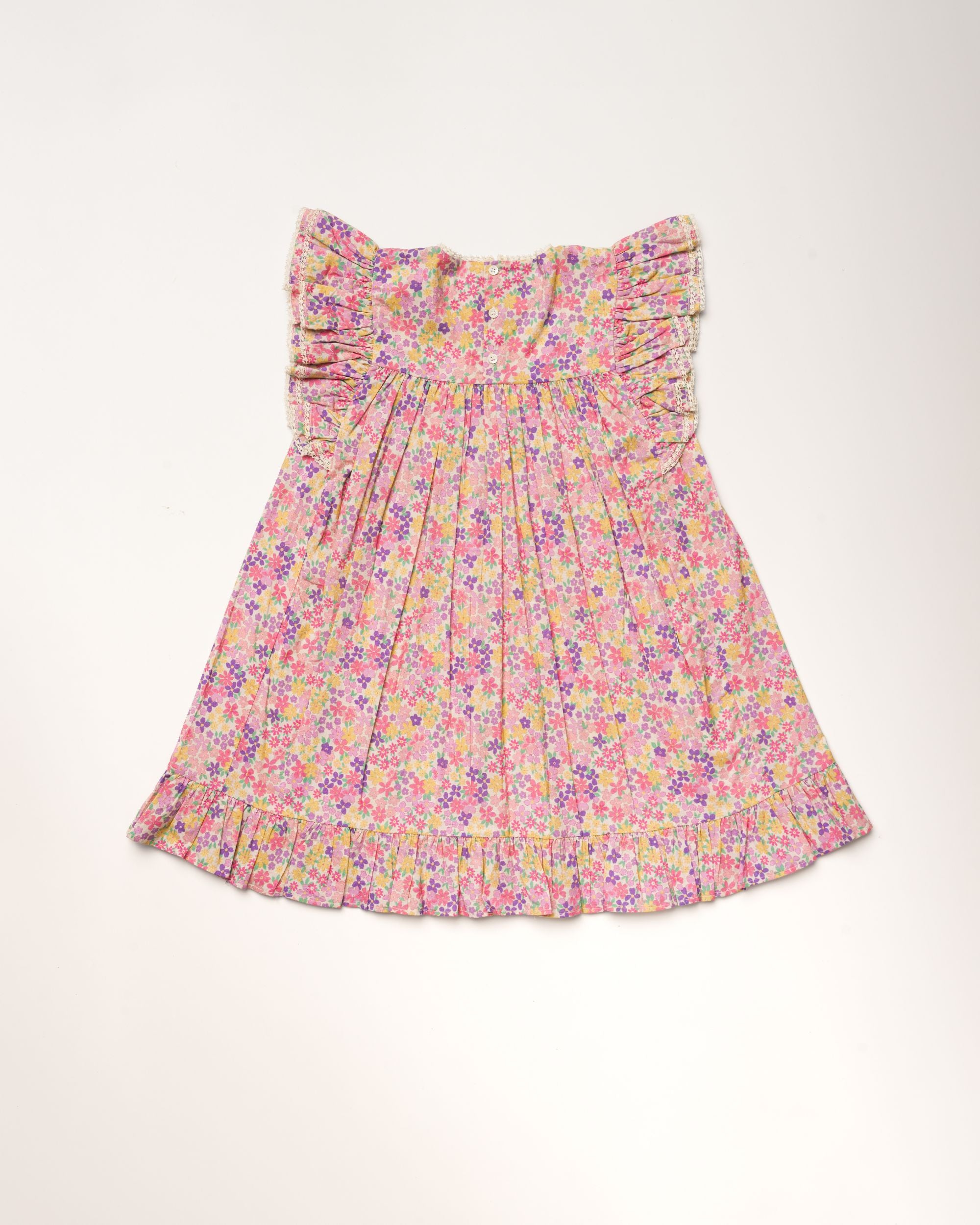 Early Sunday, Sita Dress in Emma Floral Purple color, made from Organic Printed Cotton Cambric fabric, featuring a sleeveless design with wide shoulder straps & a delicate lace yoke, shown in a back flat-lay view