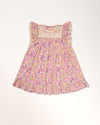 Early Sunday, Sita Dress in Emma Floral Purple color, made from Organic Printed Cotton Cambric fabric, featuring a sleeveless design with wide shoulder straps & a delicate lace yoke, shown in a front flat-lay view