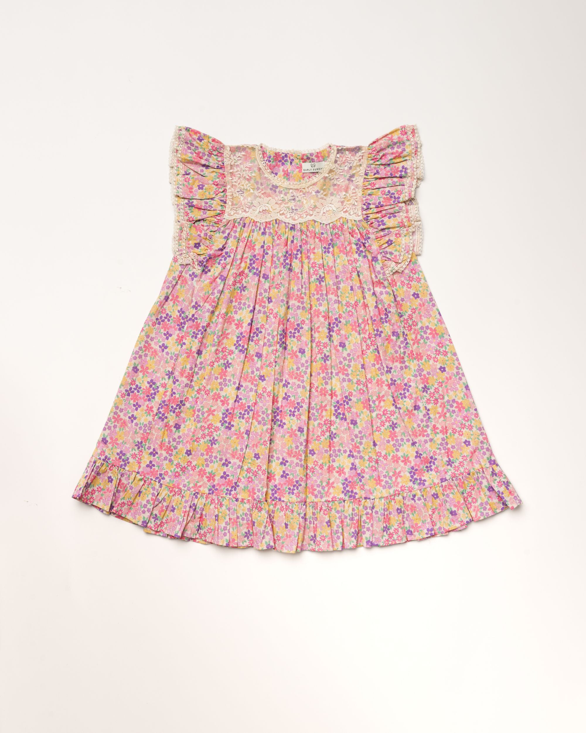 Early Sunday, Sita Dress in Emma Floral Purple color, made from Organic Printed Cotton Cambric fabric, featuring a sleeveless design with wide shoulder straps & a delicate lace yoke, shown in a front flat-lay view