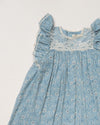 Early Sunday, Sita Dress in Tonal Floral Blue color, made from Printed Cotton Tiny Swiss Dobby fabric, featuring a sleeveless design with wide shoulder straps & a delicate lace yoke, shown in a closeup flat-lay view