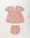 Early Sunday, Sofia Baby Dress & Bloomer Set in Emma Floral Purple color, made from 100% Organic Cotton 60s Cambric fabric, featuring short sleeves with peter pan collar, shown in a front flat-lay view