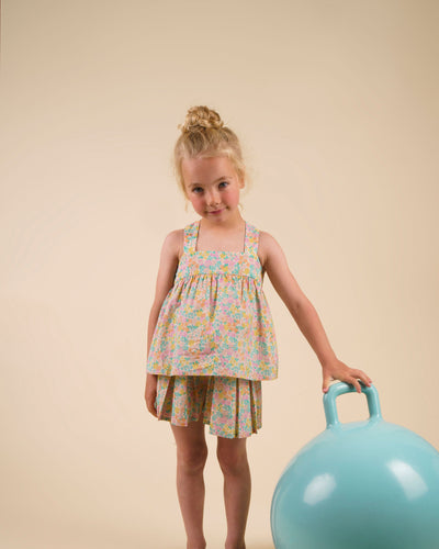 Early Sunday, Solal Skort in Emma Floral Mint color, made from Organic Printed Cotton Cambric fabric, featuring a flared skirt overlay with attached shorts & elastic waistband, shown in a front view of a model wearing it in a studio setting