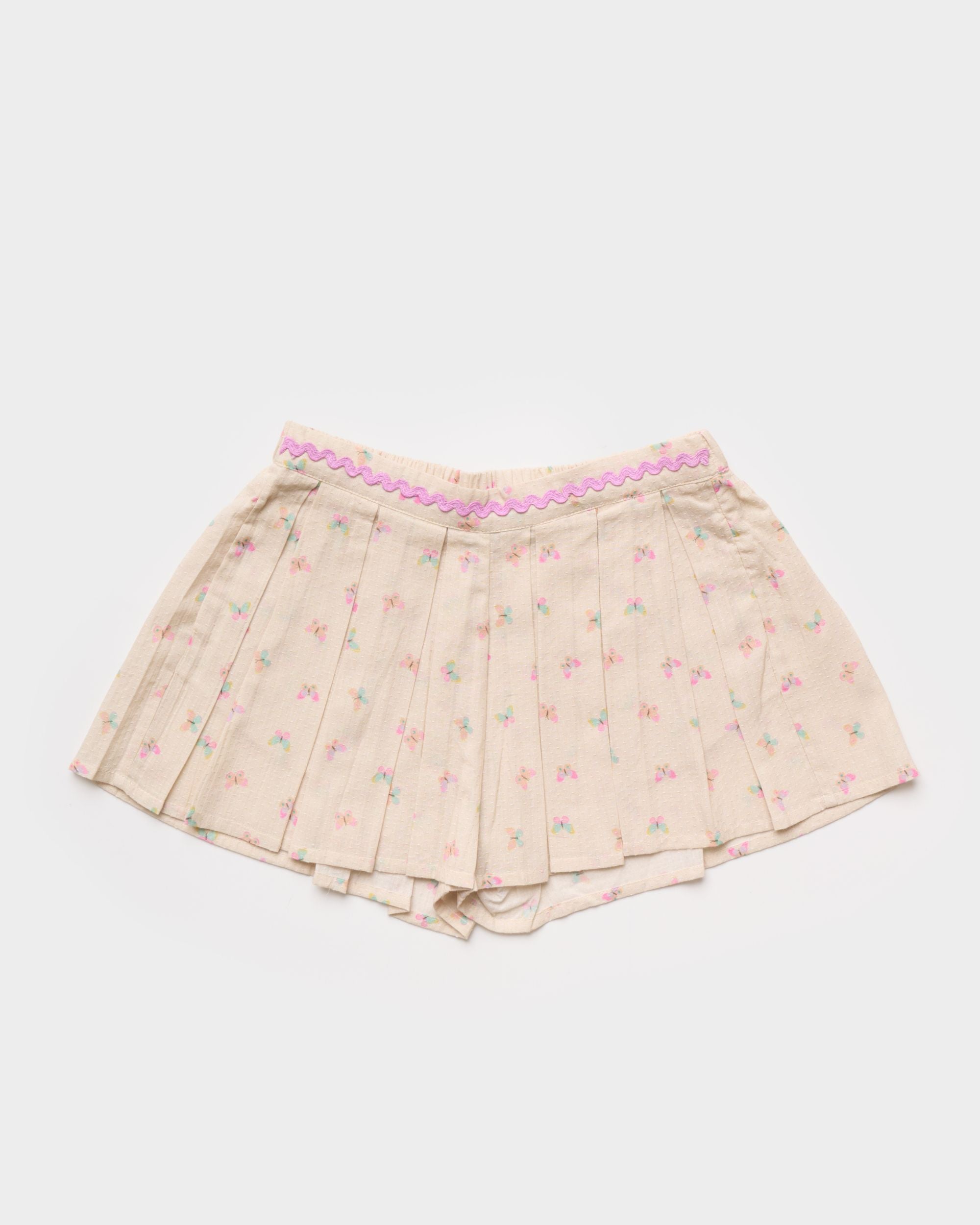 Early Sunday, Solal Skort in Butterflies print, made from Printed Cotton Tiny Swiss Dobby fabric, featuring a flared skirt overlay with attached shorts & elastic waistband, shown in a front flat-lay view