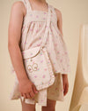 Early Sunday, Solal Skort in Butterflies print, made from Printed Cotton Tiny Swiss Dobby fabric, featuring a flared skirt overlay with attached shorts & elastic waistband, shown in a close-up shot of a model wearing it during a studio shoot