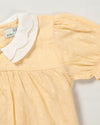 Early Sunday, Sukie Baby Dress & Bloomer in Vanilla color, made from Cotton Dobby Swiss Dots fabric, featuring flared dress with a relaxed fit for ease of movement, matching bloomer with an elasticated waistband for comfort and flexibility., shown in a closeup flat-lay view