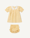 Early Sunday, Sukie Baby Dress & Bloomer in Vanilla color, made from Cotton Dobby Swiss Dots fabric, featuring flared dress with a relaxed fit for ease of movement, matching bloomer with an elasticated waistband for comfort and flexibility., shown in a front flat-lay view