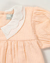 Early Sunday, Sukie Baby Dress & Bloomer in Warm Sand color, made from Cotton Seersucker fabric, featuring flared dress with a relaxed fit for ease of movement, matching bloomer with an elasticated waistband for comfort and flexibility., shown in a closeup flat-lay view
