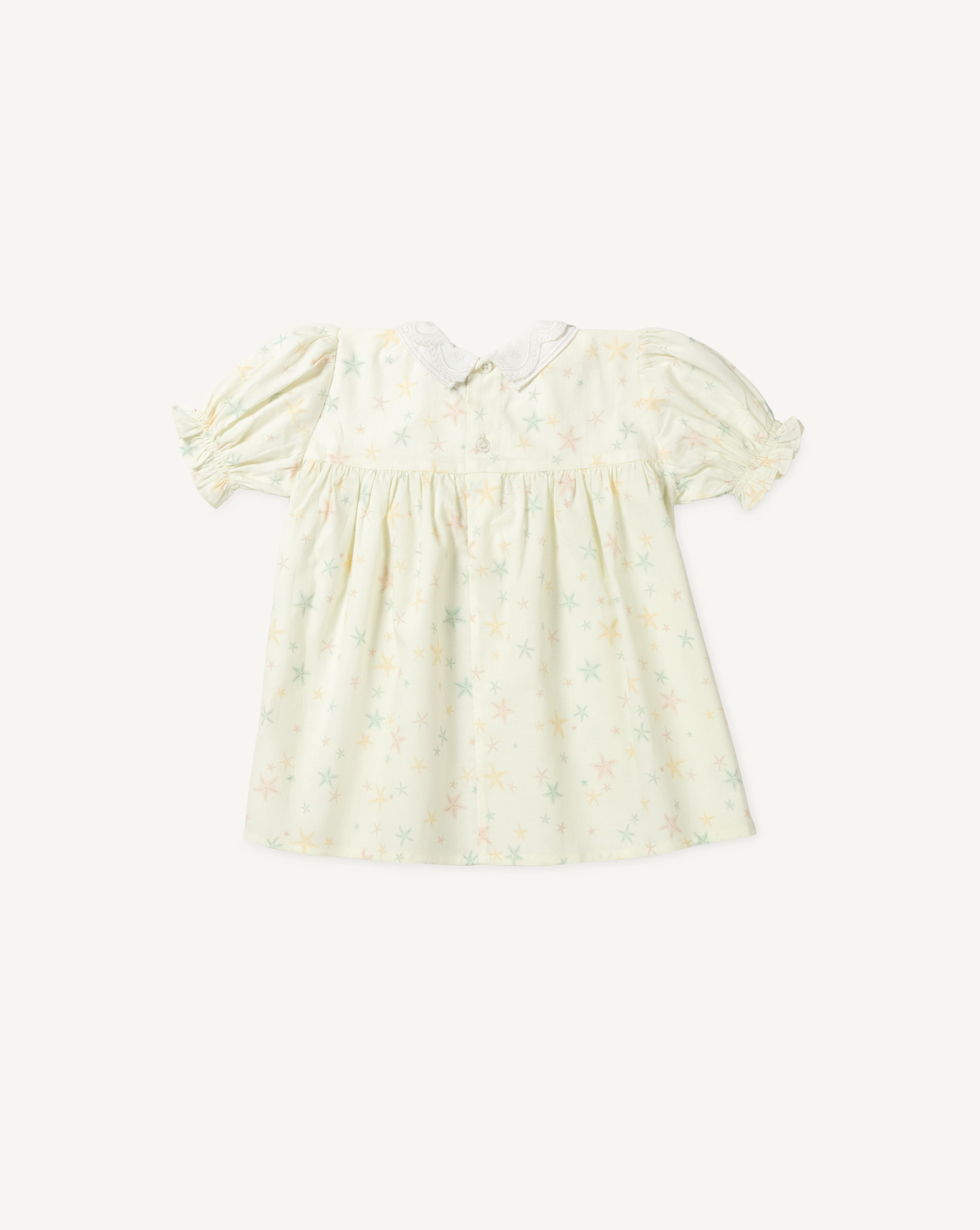 Early Sunday, Sukie Baby Dress & Bloomer in Star Fish print, made from Printed Cotton Cambric fabric, featuring flared dress with a relaxed fit for ease of movement, matching bloomer with an elasticated waistband for comfort and flexibility., shown in a back flat-lay view