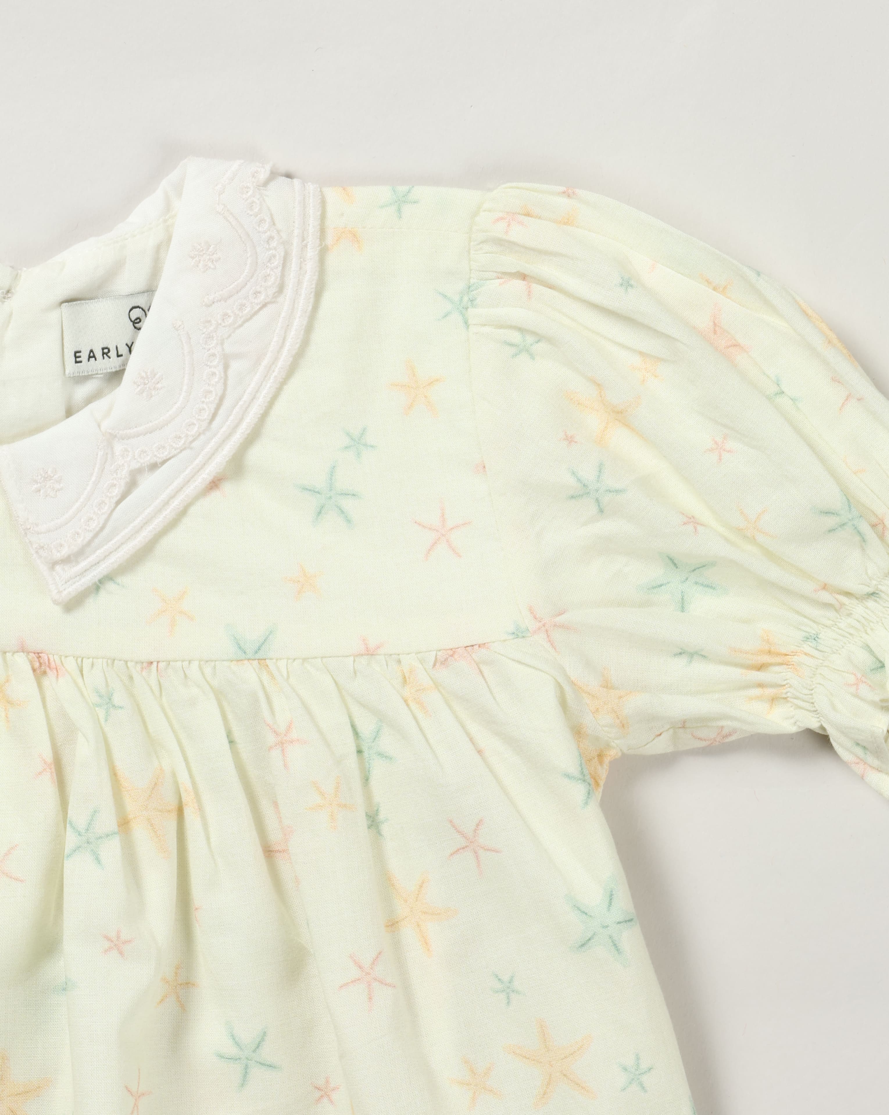 Early Sunday, Sukie Baby Dress & Bloomer in Star Fish print, made from Printed Cotton Cambric fabric, featuring flared dress with a relaxed fit for ease of movement, matching bloomer with an elasticated waistband for comfort and flexibility., shown in a closeup flat-lay view