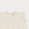 Early Sunday, Susie Baby Dress & Bloomer in Ivory color, made from All-Over Eyelet Embroidered Cotton Schifflie fabric, featuring flared dress with a relaxed fit for ease of movement, matching bloomer with an elasticated waistband for comfort and flexibility, shown in a closeup flat-lay view