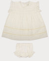 Early Sunday, Susie Baby Dress & Bloomer in Ivory color, made from All-Over Eyelet Embroidered Cotton Schifflie fabric, featuring flared dress with a relaxed fit for ease of movement, matching bloomer with an elasticated waistband for comfort and flexibility, shown in a front flat-lay view