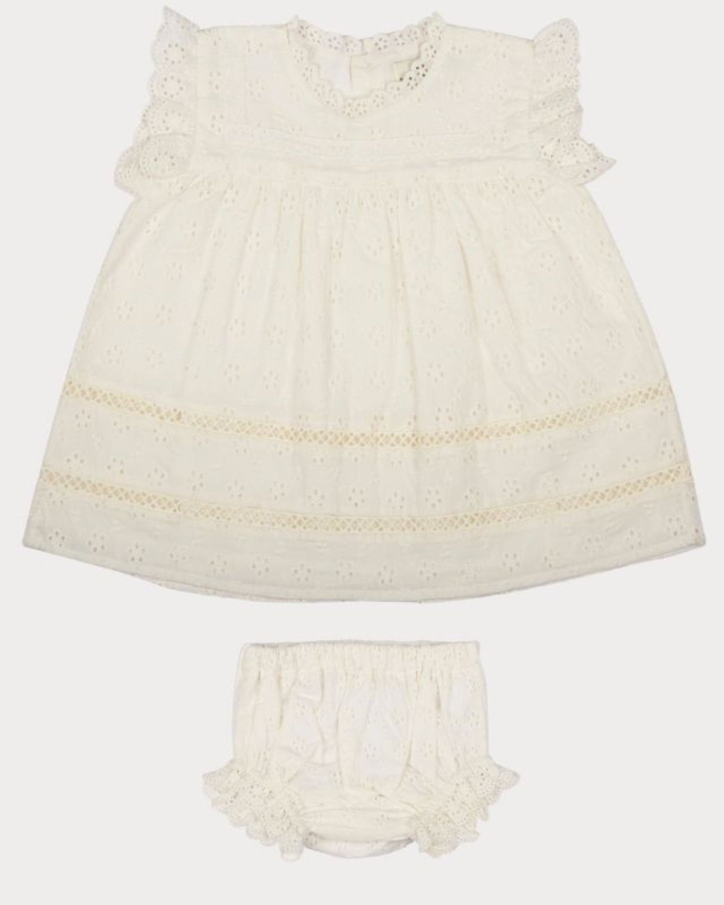 Early Sunday, Susie Baby Dress & Bloomer in Ivory color, made from All-Over Eyelet Embroidered Cotton Schifflie fabric, featuring flared dress with a relaxed fit for ease of movement, matching bloomer with an elasticated waistband for comfort and flexibility, shown in a front flat-lay view