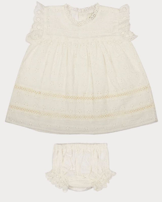 Early Sunday, Susie Baby Dress & Bloomer in Ivory color, made from All-Over Eyelet Embroidered Cotton Schifflie fabric, featuring flared dress with a relaxed fit for ease of movement, matching bloomer with an elasticated waistband for comfort and flexibility, shown in a front flat-lay view