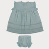 Early Sunday, Susie Baby Dress & Bloomer in Sea Dream color, made from All-Over Eyelet Embroidered Cotton Schifflie fabric, featuring flared dress with a relaxed fit for ease of movement, matching bloomer with an elasticated waistband for comfort and flexibility, shown in a back flat-lay view