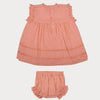 Early Sunday, Susie Baby Dress & Bloomer in Strawberry color, made from All-Over Eyelet Embroidered Cotton Schifflie fabric, featuring flared dress with a relaxed fit for ease of movement, matching bloomer with an elasticated waistband for comfort and flexibility, shown in a back flat-lay view