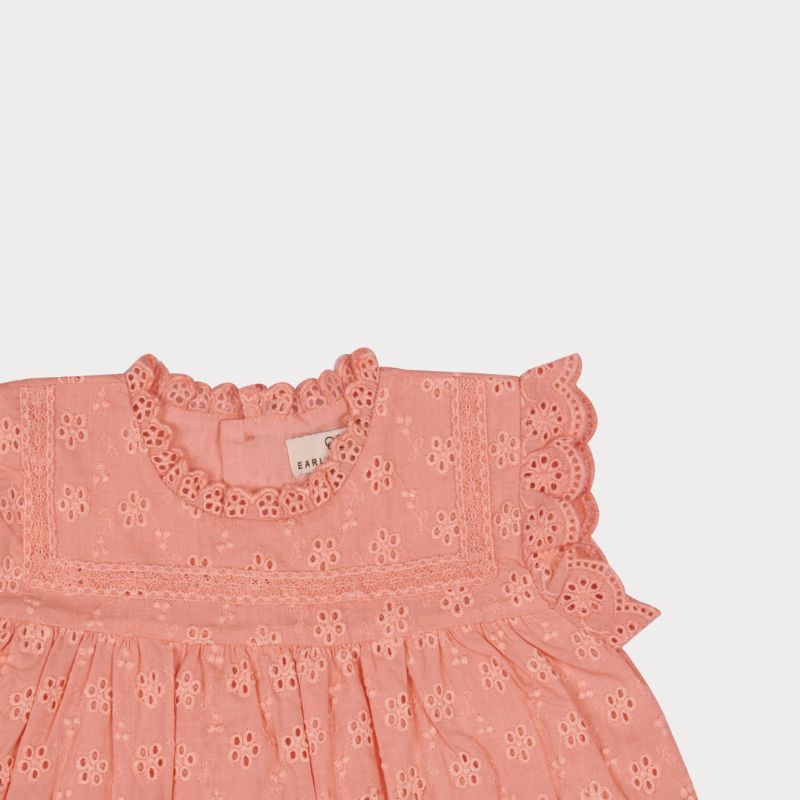 Early Sunday, Susie Baby Dress & Bloomer in Strawberry color, made from All-Over Eyelet Embroidered Cotton Schifflie fabric, featuring flared dress with a relaxed fit for ease of movement, matching bloomer with an elasticated waistband for comfort and flexibility, shown in a closeup flat-lay view