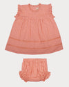 Early Sunday, Susie Baby Dress & Bloomer in Strawberry color, made from All-Over Eyelet Embroidered Cotton Schifflie fabric, featuring flared dress with a relaxed fit for ease of movement, matching bloomer with an elasticated waistband for comfort and flexibility, shown in a front flat-lay view