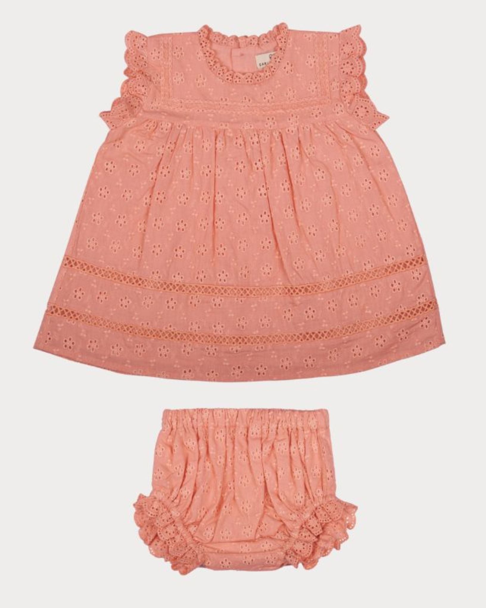 Early Sunday, Susie Baby Dress & Bloomer in Strawberry color, made from All-Over Eyelet Embroidered Cotton Schifflie fabric, featuring flared dress with a relaxed fit for ease of movement, matching bloomer with an elasticated waistband for comfort and flexibility, shown in a front flat-lay view
