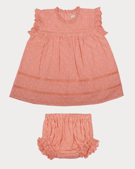 Early Sunday, Susie Baby Dress & Bloomer in Strawberry color, made from All-Over Eyelet Embroidered Cotton Schifflie fabric, featuring flared dress with a relaxed fit for ease of movement, matching bloomer with an elasticated waistband for comfort and flexibility, shown in a front flat-lay view