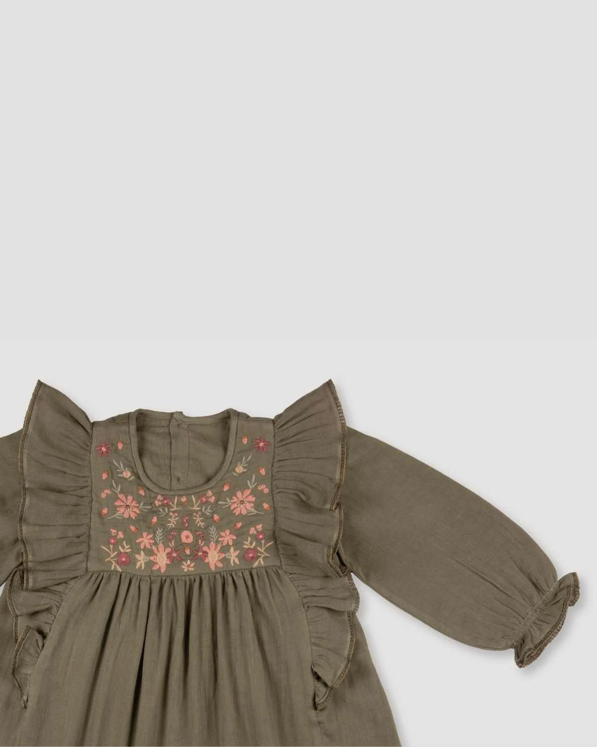 Early Sunday, Suzanne Dress in Dried Leaf, made from Cotton Double Gauze fabric, featuring classic silhouette with floral embroidery around the yoke and ruffle detailing, shown in a closeup flat-lay view