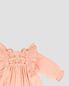 Early Sunday, Suzanne Dress in Dusty Pink, made from Cotton Double Gauze fabric, featuring classic silhouette with floral embroidery around the yoke and ruffle detailing, shown in a closeup flat-lay view