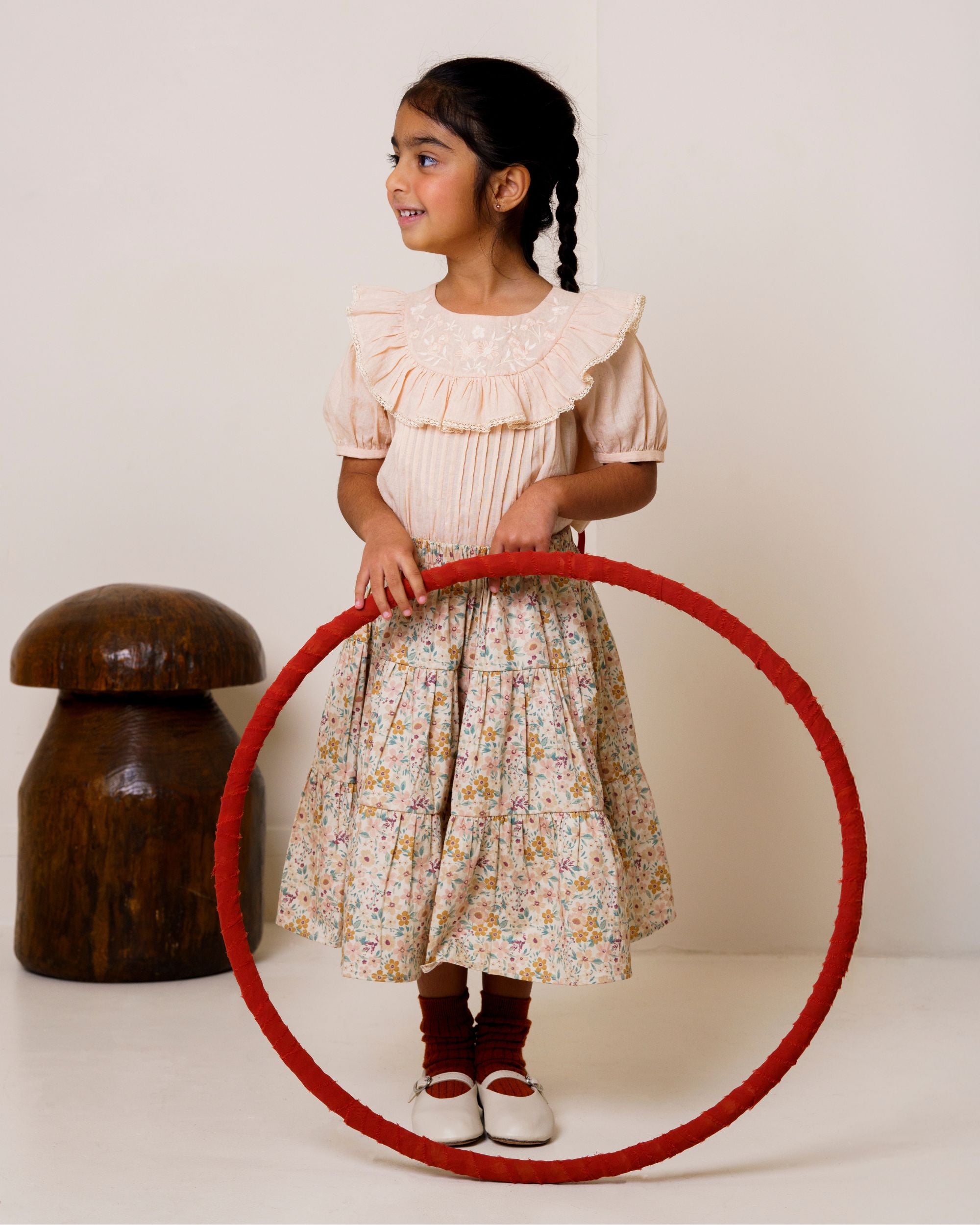 Early Sunday, Victoria Skirt in Floral print, made from Printed Cotton Satin fabric, featuring Tiered silhouette for natural movement and volume, shown in a front view of model wearing it
