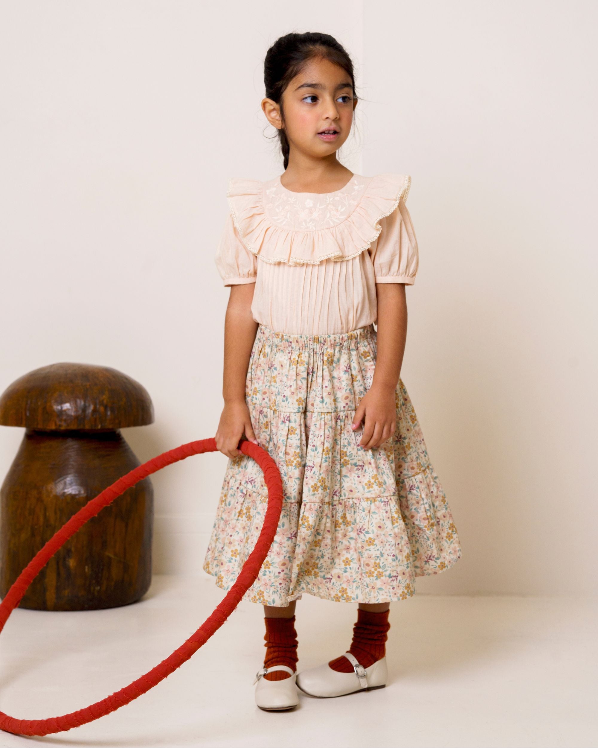 Early Sunday, Victoria Skirt in Floral print, made from Printed Cotton Satin fabric, featuring Tiered silhouette for natural movement and volume, shown in a side view of model wearing it
