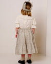 Early Sunday, Victoria Skirt in Miny Flowers print, made from Printed Cotton Satin fabric, featuring Tiered silhouette for natural movement and volume, shown in a back view of model wearing it