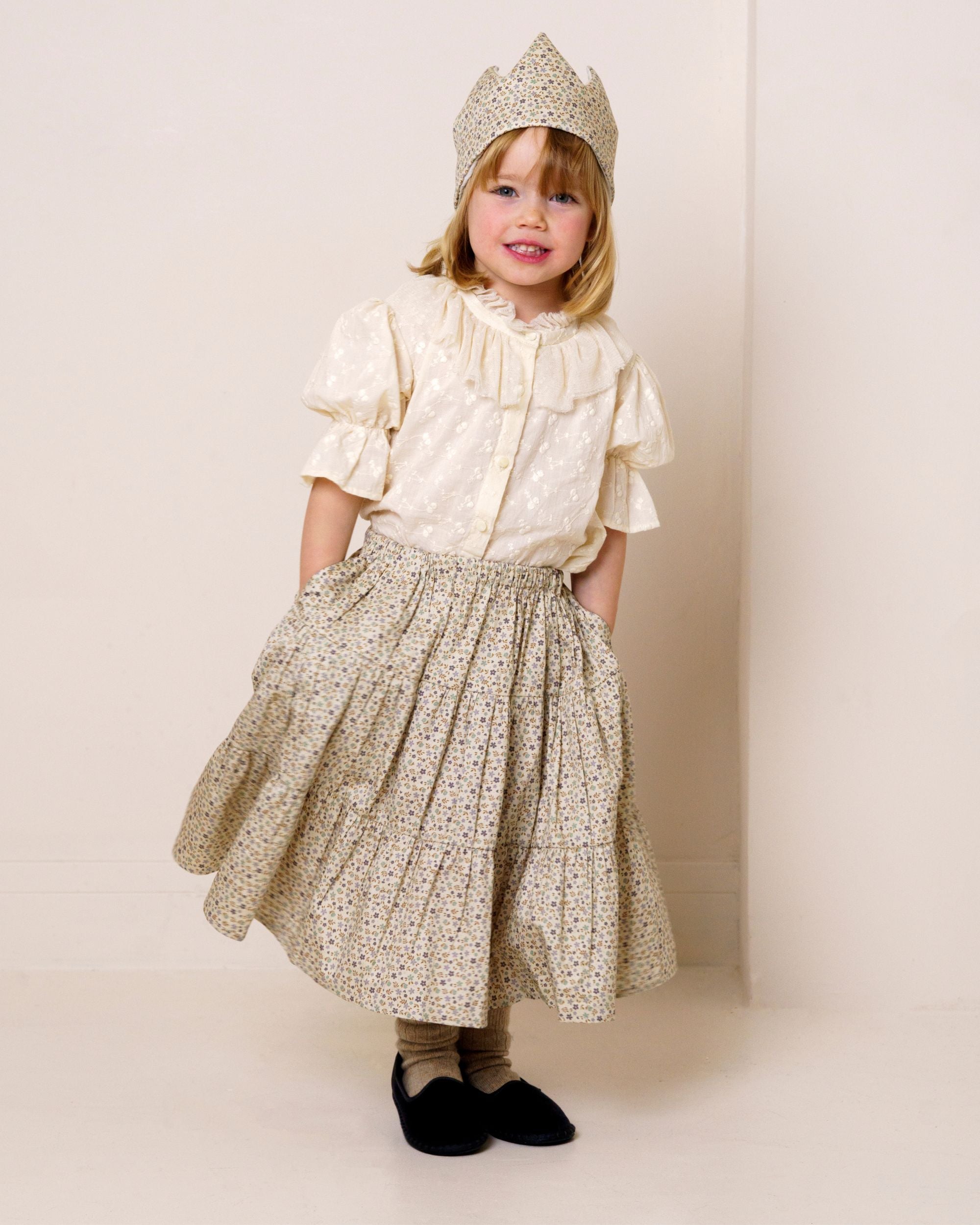 Early Sunday, Victoria Skirt in Miny Flowers print, made from Printed Cotton Satin fabric, featuring Tiered silhouette for natural movement and volume, shown in a side view of model wearing it