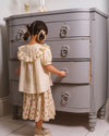 Early Sunday, Victoria Skirt in Ditsy Bouquet Cream print, made from Printed Viscose Rayon Twill fabric, featuring Tiered silhouette for natural movement and volume, shown in a back view of model wearing it