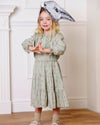 Early Sunday, Victoria Skirt in Ditsy Bouquet Jade print, made from Printed Viscose Rayon Twill fabric, featuring Tiered silhouette for natural movement and volume, shown in a side view of model wearing it