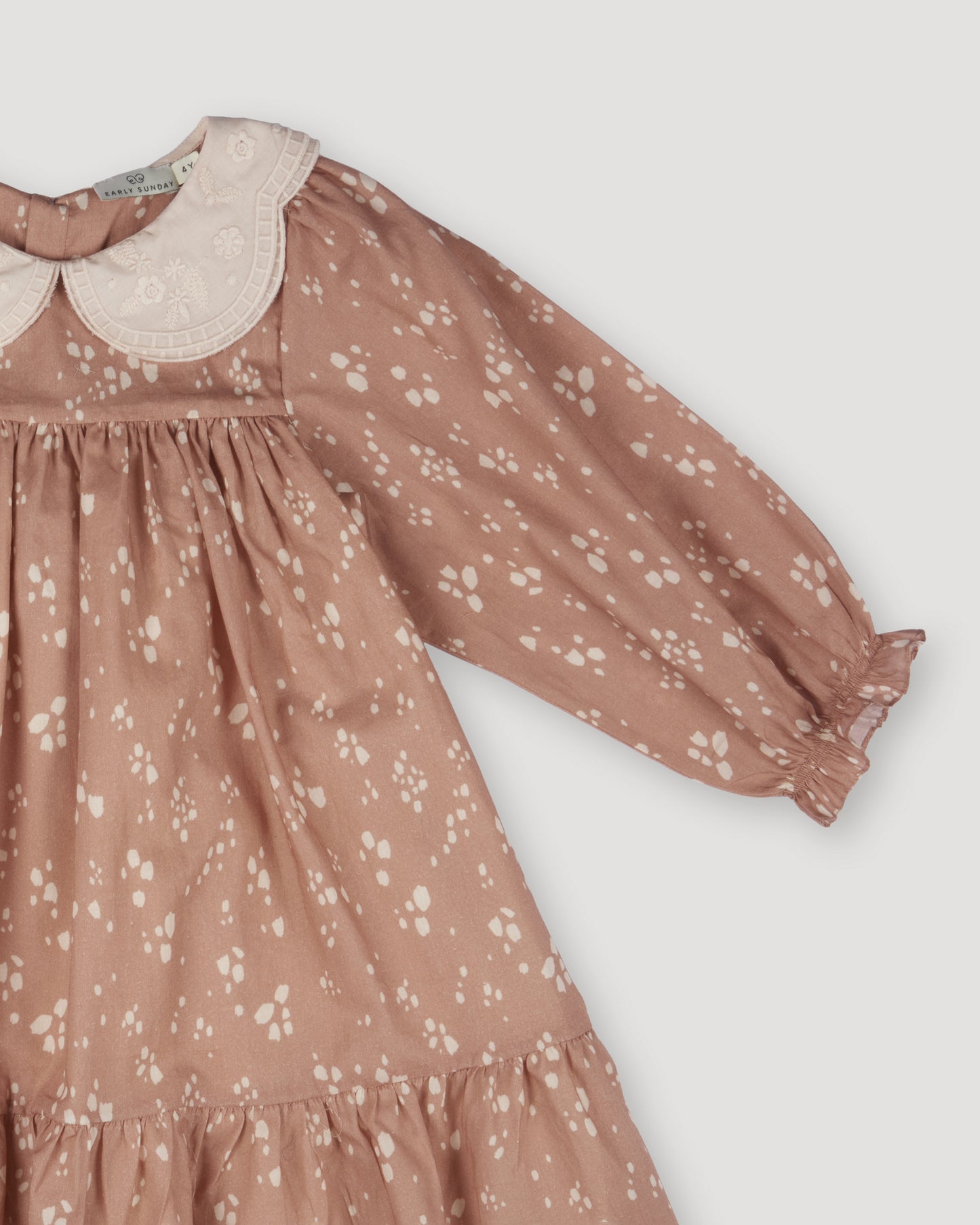 Early Sunday, Virginia Dress in Fawn Soft Pinkish Brown, made from Printed Cotton Cambric fabric, featuring classic silhouette with embroidered collars, shown in a closeup flat-lay view