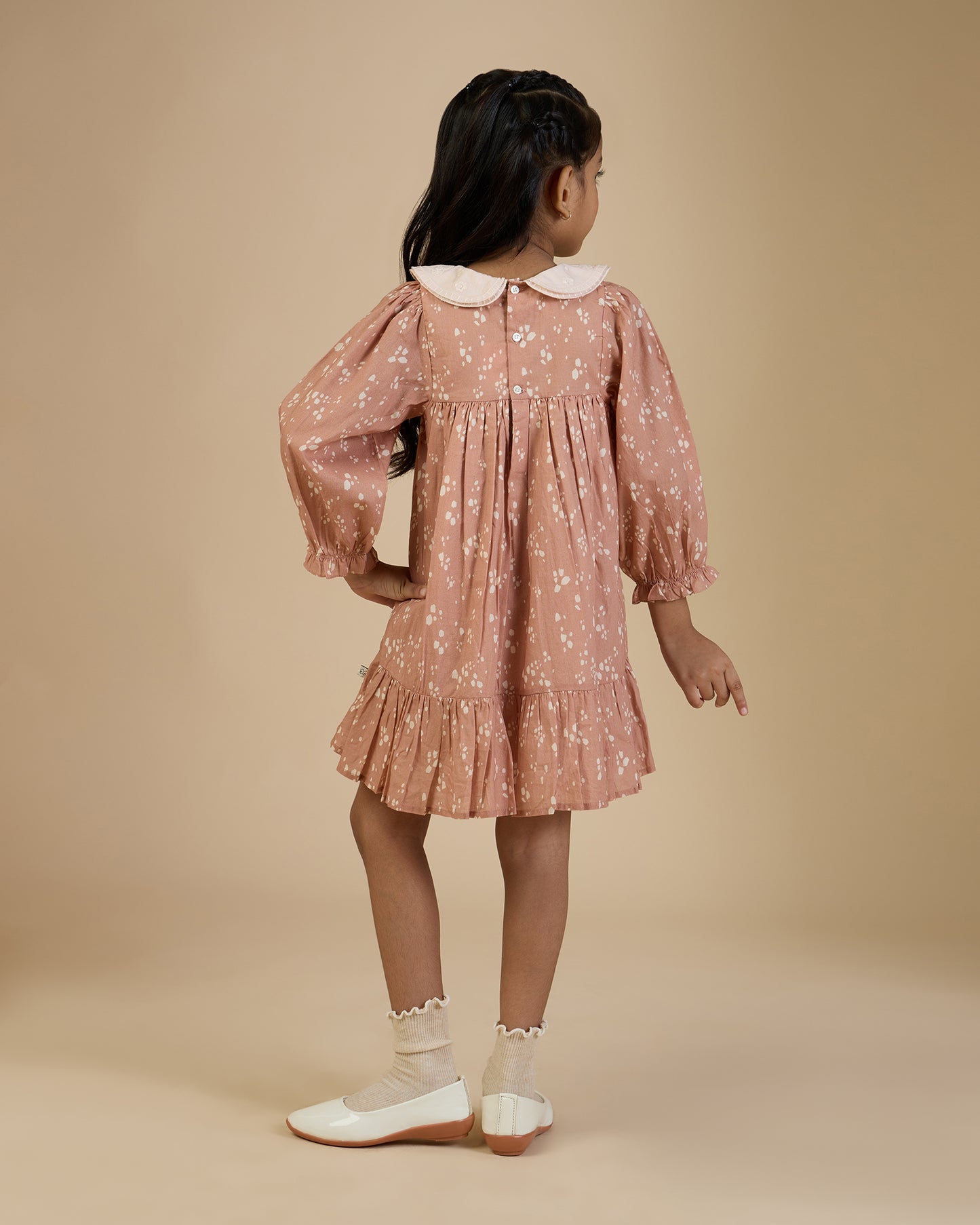 Early Sunday, Virginia Dress in Fawn Soft Pinkish Brown, made from Printed Cotton Cambric fabric, featuring classic silhouette with embroidered collars, shown in a back view of model wearing it