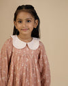 Early Sunday, Virginia Dress in Fawn Soft Pinkish Brown, made from Printed Cotton Cambric fabric, featuring classic silhouette with embroidered collars, shown in a close-up shot of a model wearing it during a studio shoot
