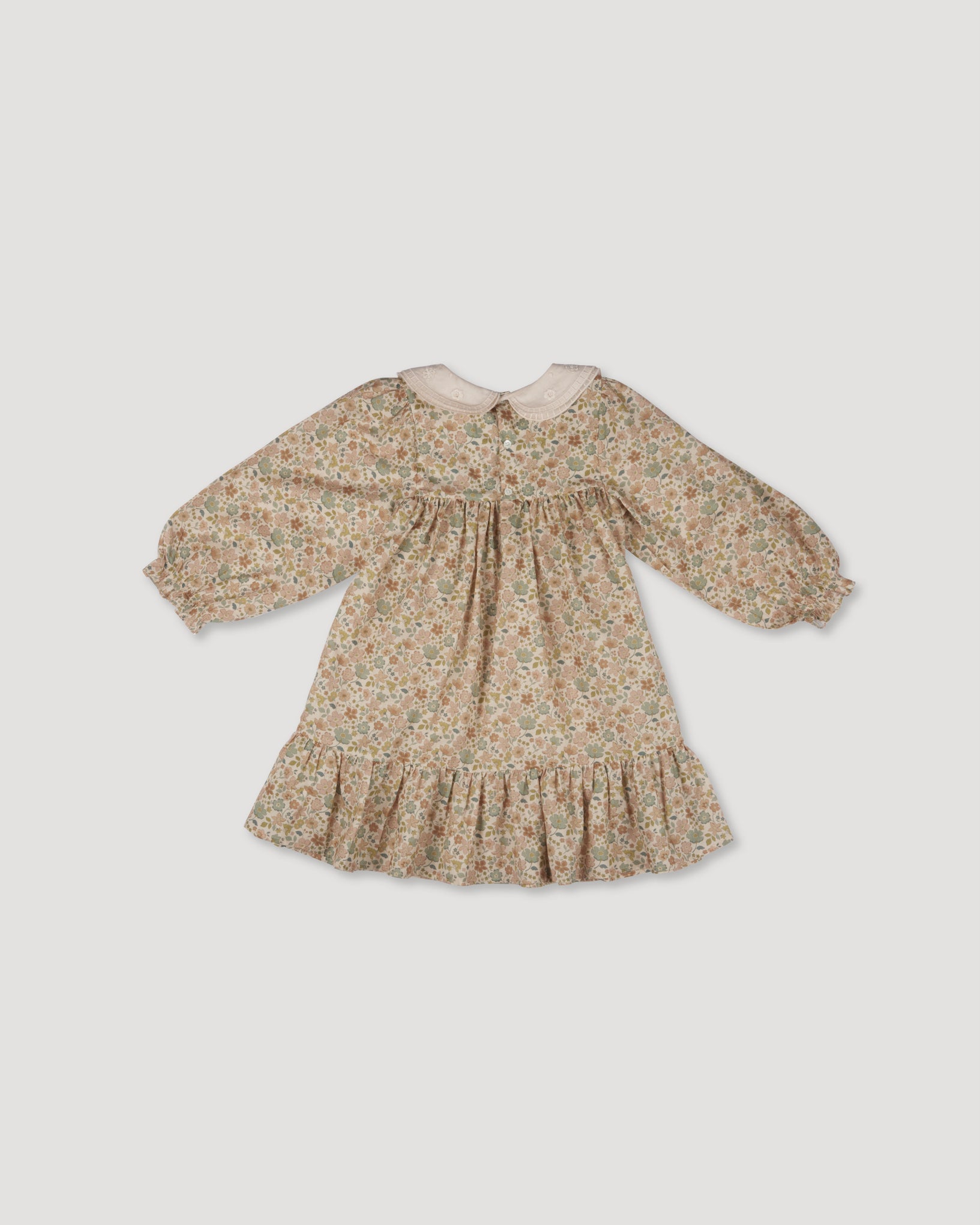 Early Sunday, Virginia Dress in Garden Flowers Cream, made from Printed Cotton Cambric fabric, featuring classic silhouette with embroidered collars, shown in a back flat-lay view