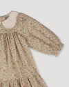 Early Sunday, Virginia Dress in Garden Flowers Cream, made from Printed Cotton Cambric fabric, featuring classic silhouette with embroidered collars, shown in a closeup flat-lay view