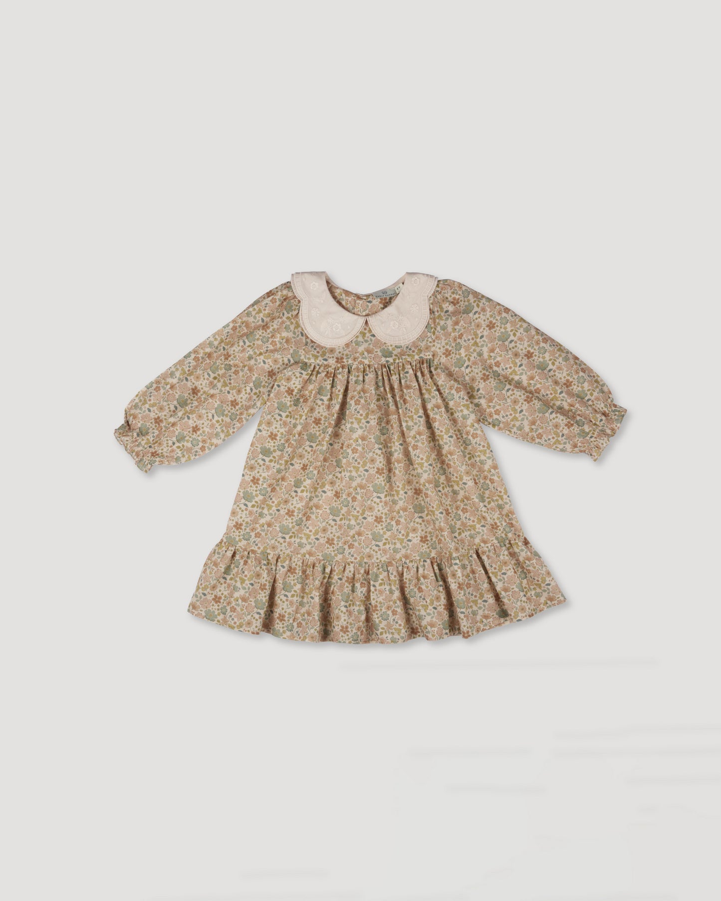 Early Sunday, Virginia Dress in Garden Flowers Cream, made from Printed Cotton Cambric fabric, featuring classic silhouette with embroidered collars, shown in a front flat-lay view