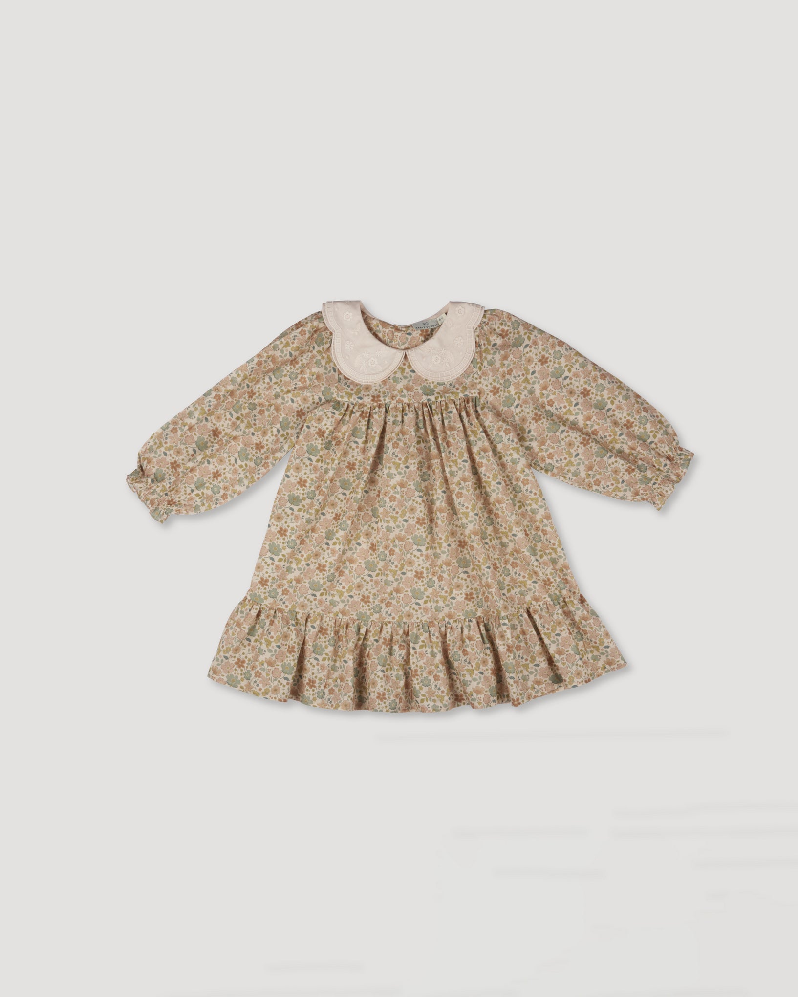 Early Sunday, Virginia Dress in Garden Flowers Cream, made from Printed Cotton Cambric fabric, featuring classic silhouette with embroidered collars, shown in a front flat-lay view